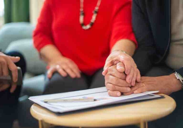 holding-hands-on-a-signed-document